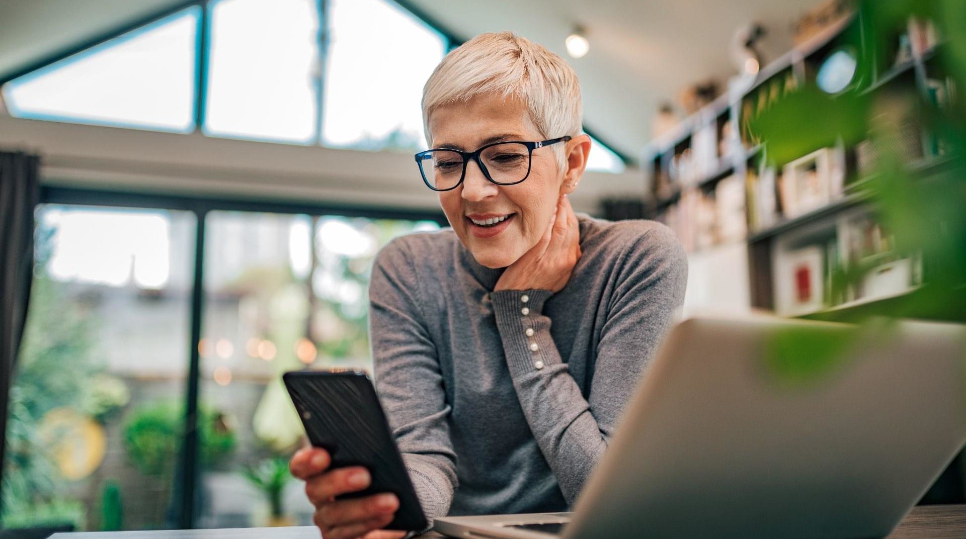 Older woman on phone and laptop