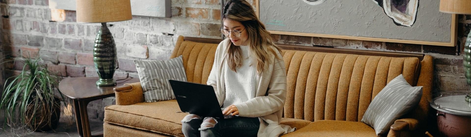 woman on couch, browsing internet