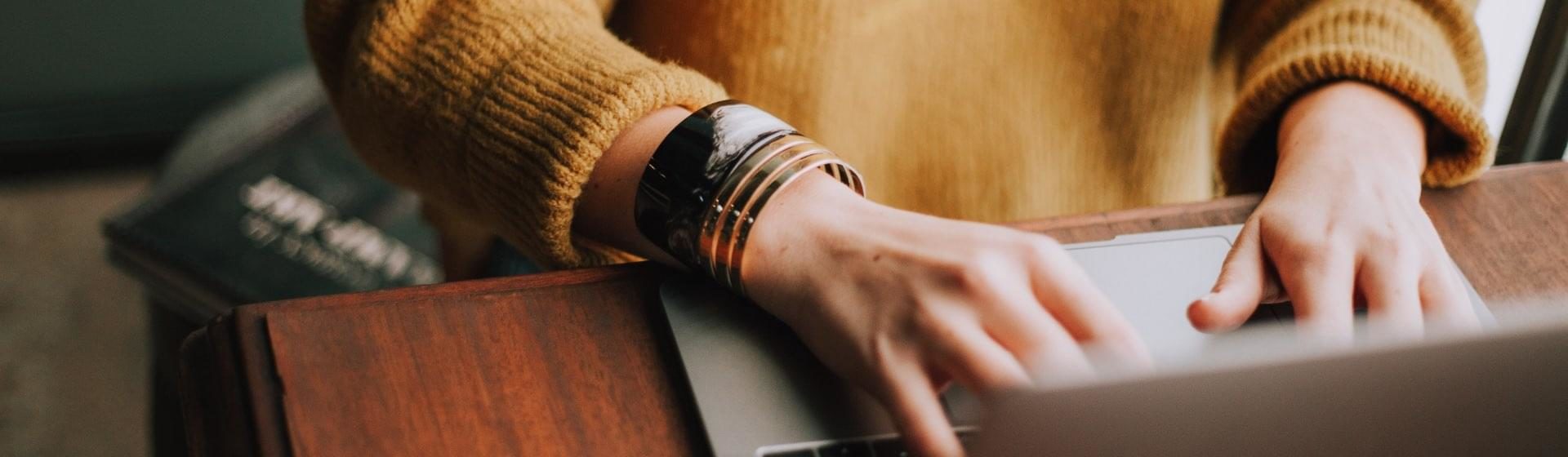 woman typing on laptop